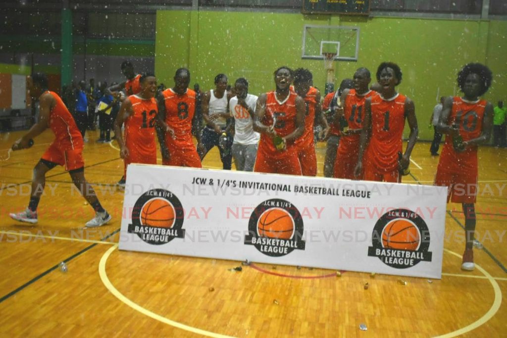 In this Dec 15, file photo, Stories of Success basketball players celebrate winning the JCW and 1/4’s Invitational Basketball League. - Sherdon Pierre
