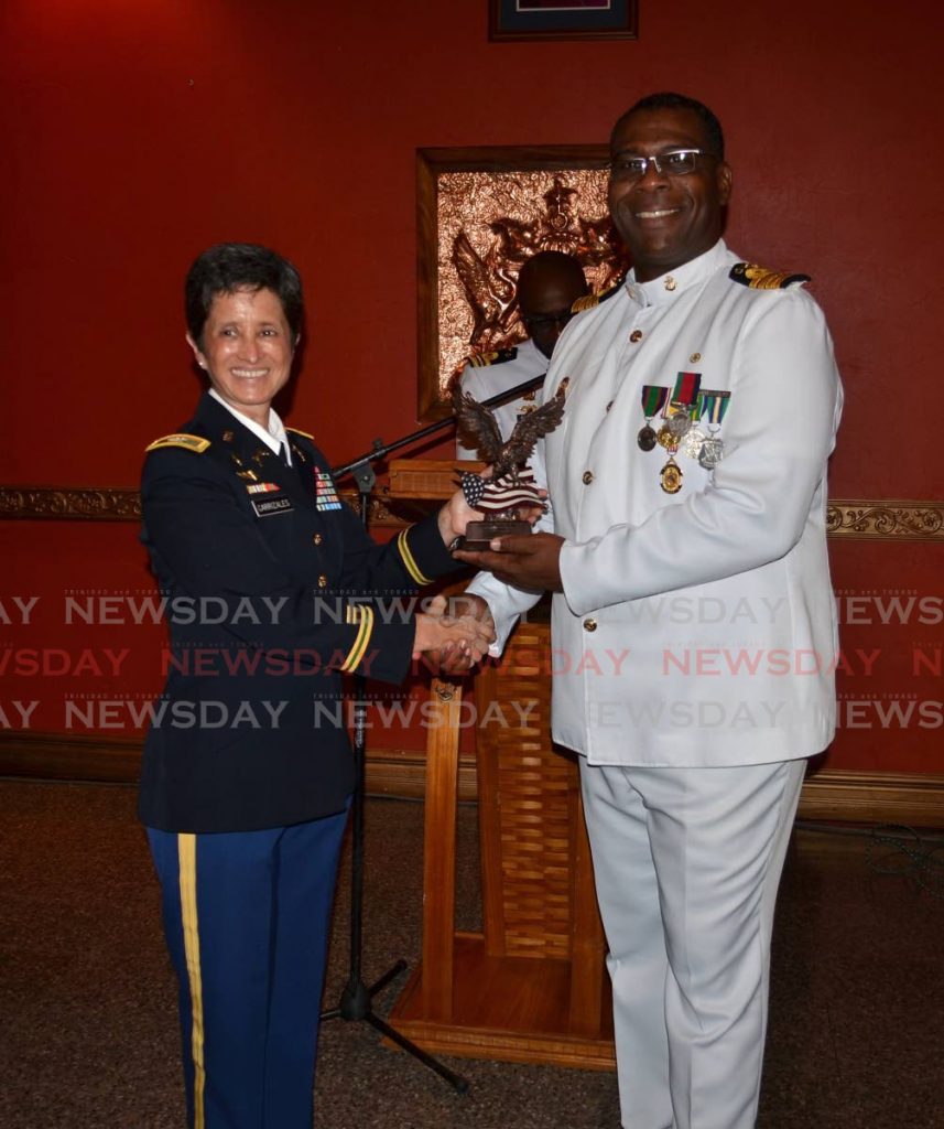 United States Embassy's Defence Attache Colonel Claudia Carrizales, presents a token to Capt Douglas Archer.
 - Joan Rampersad