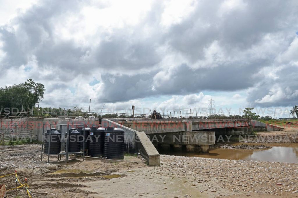 Work on the bridge at the Oropouche River, Debe nears complete on Saturday. - Marvin Hamilton