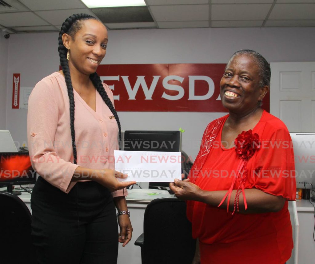 Adelaide Chambers collects her cheque for $5000 after she was selected as a the first weekly winner of Newsday's Christmas Code Cracker promotion.  PHOTO BY ROGER JACOB - ROGER JACOB