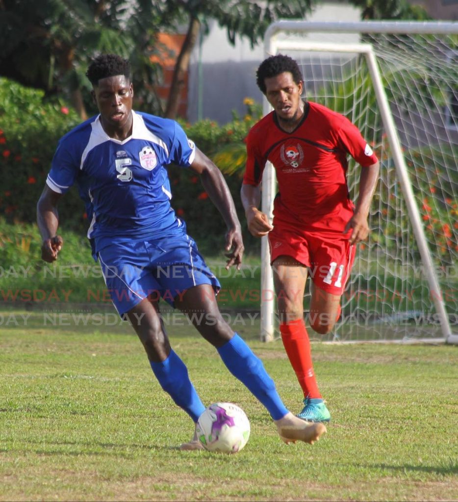 Kendis Garcia (R), of Matura ReUnited, chases Bethel United's Shaquiele Gardner (L) for the ball during the TT Super League match, held on Saturday, at the Matura Recreation Grounds, Matura. - Roger Jacob