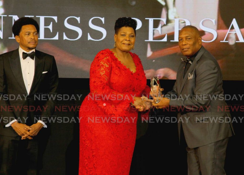 President Paula-Mae Weekes (centre) presents the Alexander B Chapman Award to NAAA president Ephraim Serrette (right), on behalf of veteran track and field coach Gunness Persad, at the TTOC award ceremony, at the Hyatt Regency Hotel, Port of Spain on Sunday. Also in photo is TTOC president Brian Lewis. PHOTO BY ROGER JACOB. - ROGER JACOB