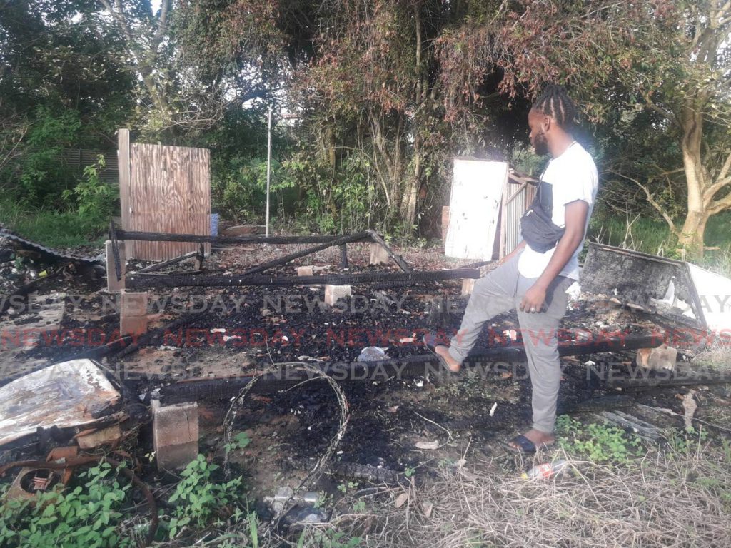 NEEDS HELP: Young Central farmer, Khareem Neptune, looks at the gutted remains of his two-room home at Chase Village in Chaguanas. PHOTO BY VALDEEN SHEARS  - 
