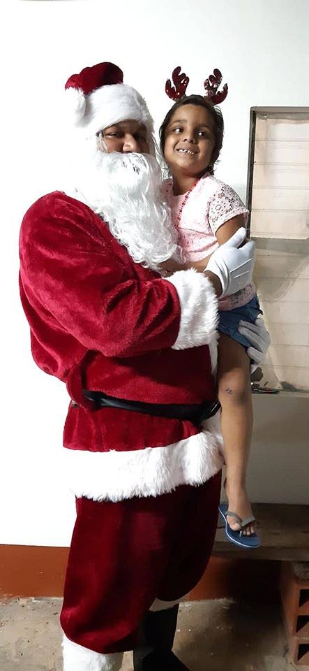 Four-year-old Arianna Maharaj got to house call from Santa Clause courtesy the Mendez Sporting Club.  - Jonathan Ramnanansingh