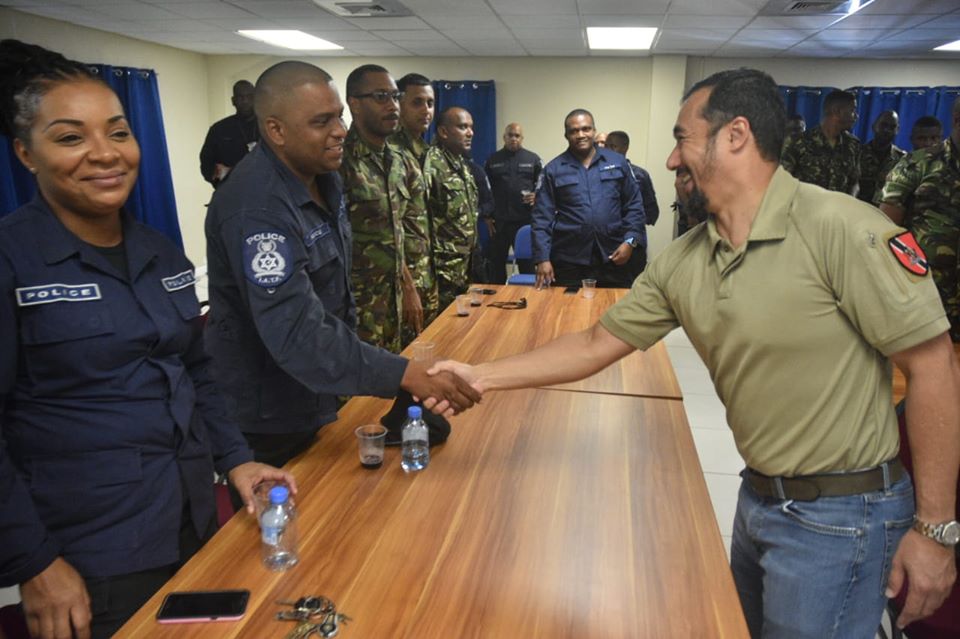 SHAKE ON IT: National Security Minister Stuart Young greet officers during his visit on Wednesday to the Inter Agency Task Force office in Port of Spain. PHOTO COURTESY TTPS 