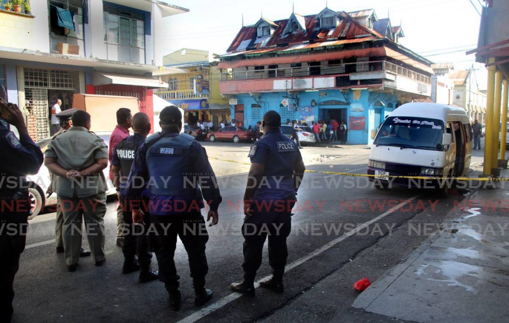 CRIME SCENE: Police at George Street in Port of Spain where nine people were shot, one fatally, at the Blanchisseuse taxi stand. PHOTO BY SUREASH CHOLAI - Sureash Cholai