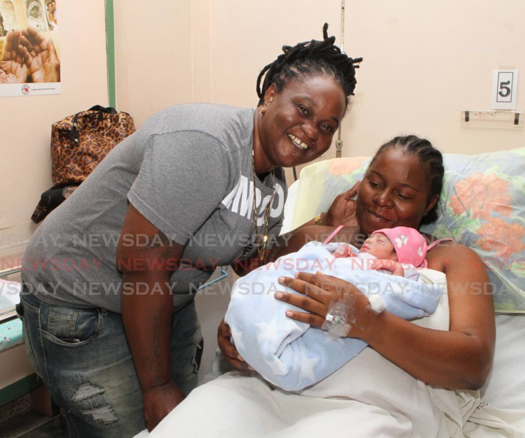 Lisa Melville, left, and Shackiba St Louis celebrate the birth of their daughter, Miracle, at the Mt Hope Women's Hospital on New Year's Day. PHOTO BY ANGELO MARCELLE. - Angelo Marcelle