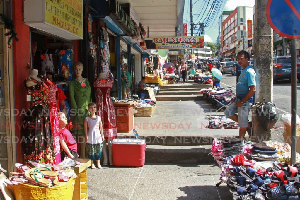 A sidewalk on High Street is mostly empty of shoppers as San Fernando vendors and storeowners said sales are slow at the start of the new year. - Marvin Hamilton