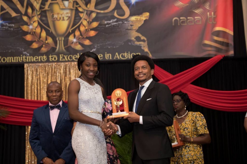 Shaniqua Bascombe wins Youth Female Athlete of the Year at the NAAA awards on Saturday, Radisson Hotel, port of Spain. TT Olympic Commitee president Brian Lewis, right, was present to hand out the award. PHOTO BY DENNIS ALLEN/TT Gameplan - Dennis Allen for TTGameplan
