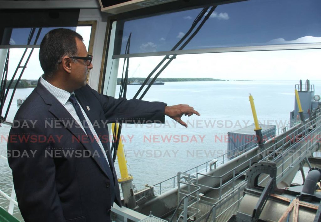 Minister of Works and Transport Rohan Sinanan explains the dredging process being done by the Lesse at the Port of Port of Spain on Wednesday.  PHOTO BY AYANNA KINSALE - AYANNA KINSALE