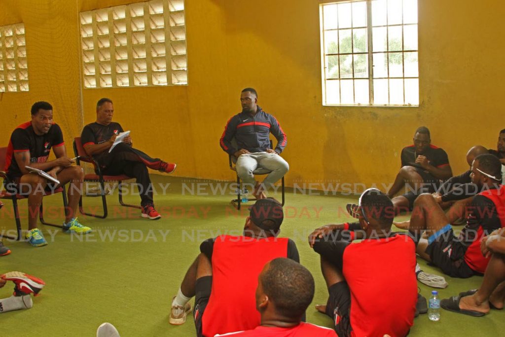 TT Red Force coach Mervyn Dillon, left, along with manager David Furlonge, second from left, and captain Darren Bravo in a team meeting at the National Cricket Centre in Couva, on Wednesday.  - Marvin Hamilton