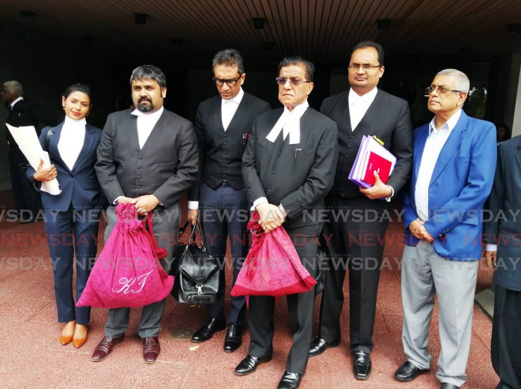 The legal team representing the late Satnarayan Maharaj and his television and radio stations, led by Senior Counsel Ramesh Lawrence Maharaj, outside the Hall of Justice after the ruling. At far right is Vijay Maharaj - son of Satnarayan Maharaj. PHOTO BY KEINO SWAMBER - KEINO SWAMBER