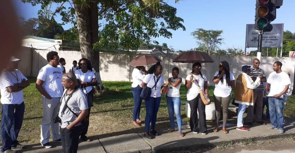 Parents and students protest outside the Point Fortin  East secondary school.  - 