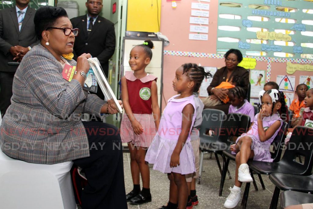 STORYTIME: Children at the All-In-One Development Centre at Beetham Gardens listen to President Paula-Mae Weekes as she reads a story to them on Wednesday.  PHOTO BY ANGELO MARCELLE - Angelo Marcelle