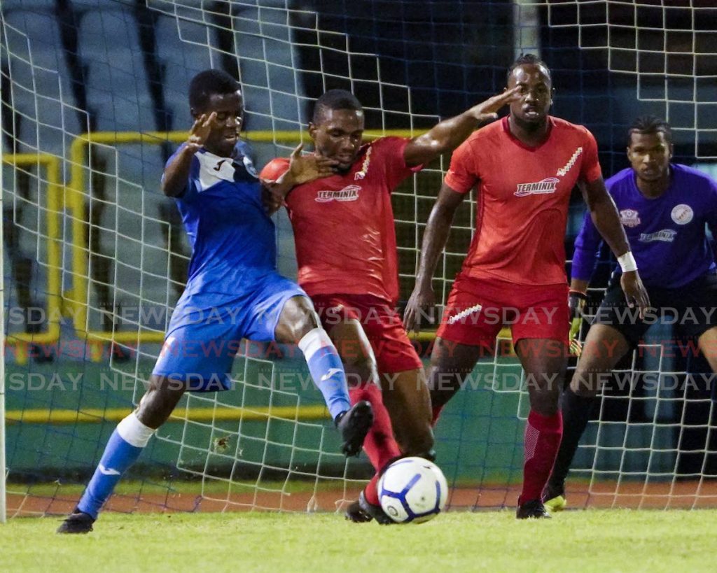 These players vie for the ball during the TT Pro League match between Police FC and Terminix La Horquetta Rangers at the Hasely Crawford Stadium, Couva. Rangers won 2-1.  - Daniel Prentice/CA-images