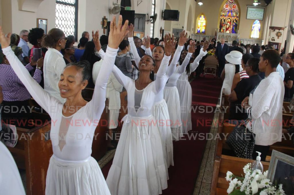 DANCE OF PRAISE: Dancers lead the casket of Patricia Roe out of the All Saints Anglican Church in Port of Spain on Tuesday.  PHOTO BY SUREASH CHOLAI - SUREASH CHOLAI
