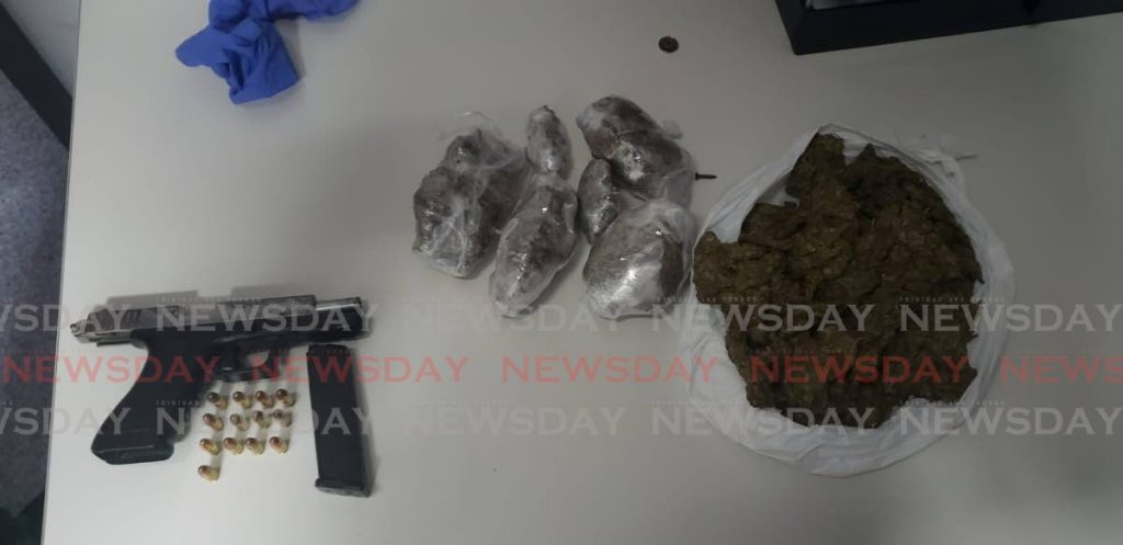 A Glock 17 pistol, 13 rounds of ammunition and one kilogram of marijuana were seized from a man at Building 21 Maloney on Tuesday night.   PHOTO COURTESY TTPS - Shane Superville