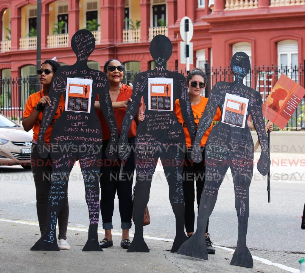 Members of civil society organisations display honour victims gender-based violence during a rally at Woodford Square, Port of Spain, on Saturday. PHOTO BY SUREASH CHOLAI - SUREASH CHOLAI