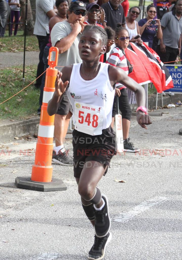 Aniqah Bailey finishes the Kiss 5k in first place among the women on Saturday evening, Queen’s Park Savannah. - ANGELO_MARCELLE