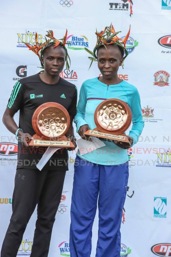 Mexico’s Stephen Njoroge (L) and Kenya’s Hellen Mugo display their awards after winning the men and women’s categories respectively, at the 2020 TT International Marathon, at the Queen's Park Savannah, on Sunday morning. - JEFF K MAYERS