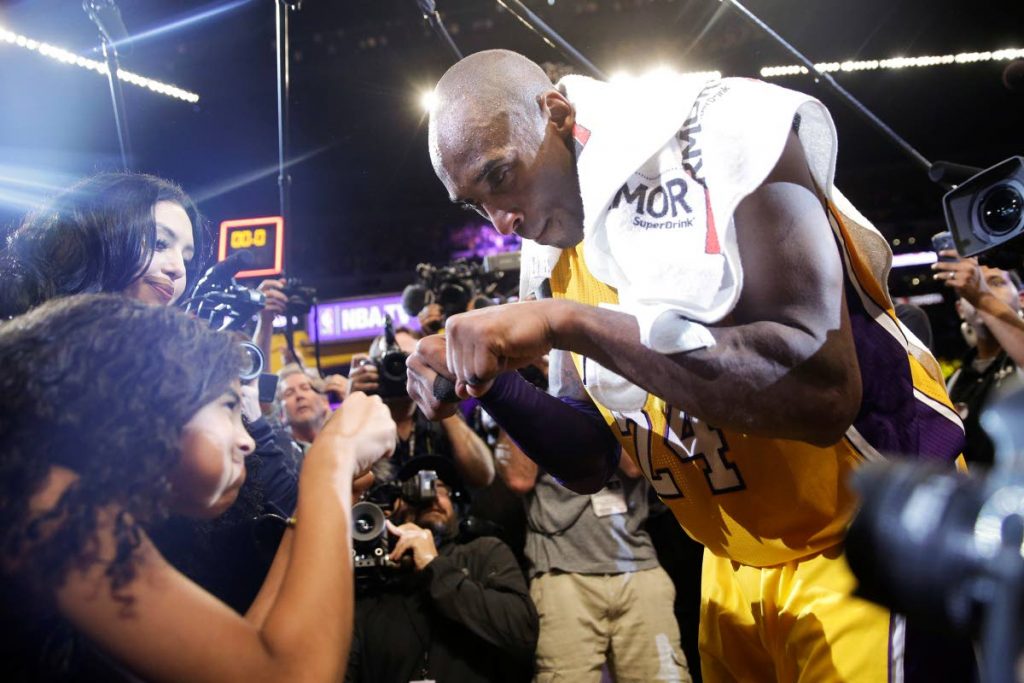 Los Angeles Lakers' Kobe Bryant, right, fist-bumps his daughter Gianna after the last NBA basketball game of his career, against the Utah Jazz in Los Angeles on April 13, 2016. Kobe scored 60 points in a victory. Kobe and Gianna died on Sunday in an accident.  - AP
