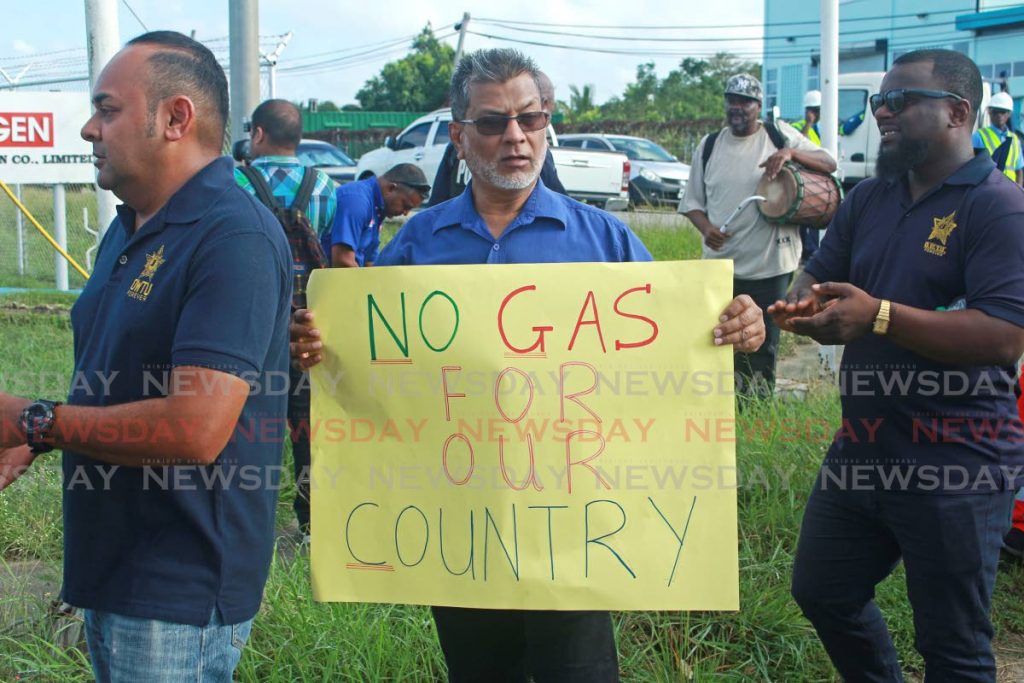 An OWTU protester holds a placard outside the YAYA Plant at Point Lisas on Wednesday morning. - CHEQUANA WHEELER