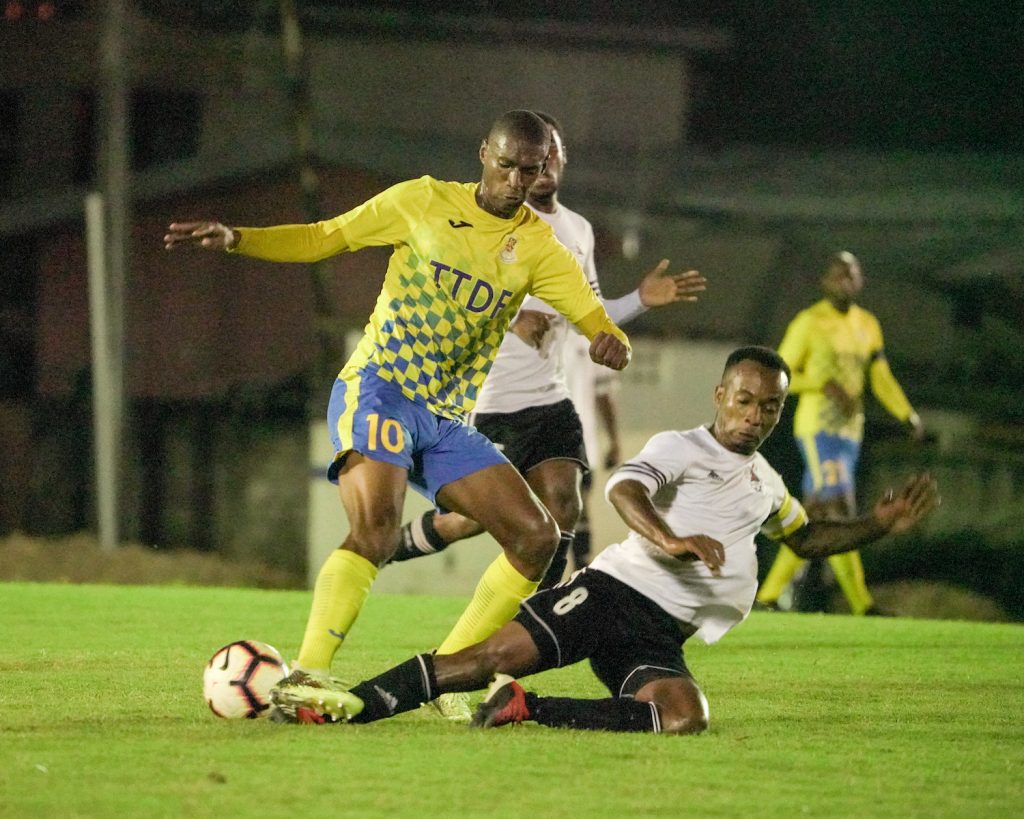Central FC skipper Kevon Goddard (R) tackles Defence Force's Hashim Arcia during the TT Pro League match, at the Phase II Recreational Facility,La Horquetta, on Tuesday. 
