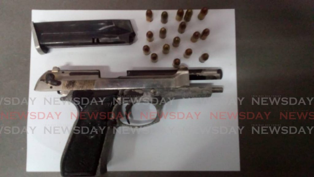 Beretta pistol and 17 rounds of ammunition were seized at an apartment building in Duncan Street, Port of Spain on Thursday night.  PHOTO COURTESY TTPS - Shane Superville