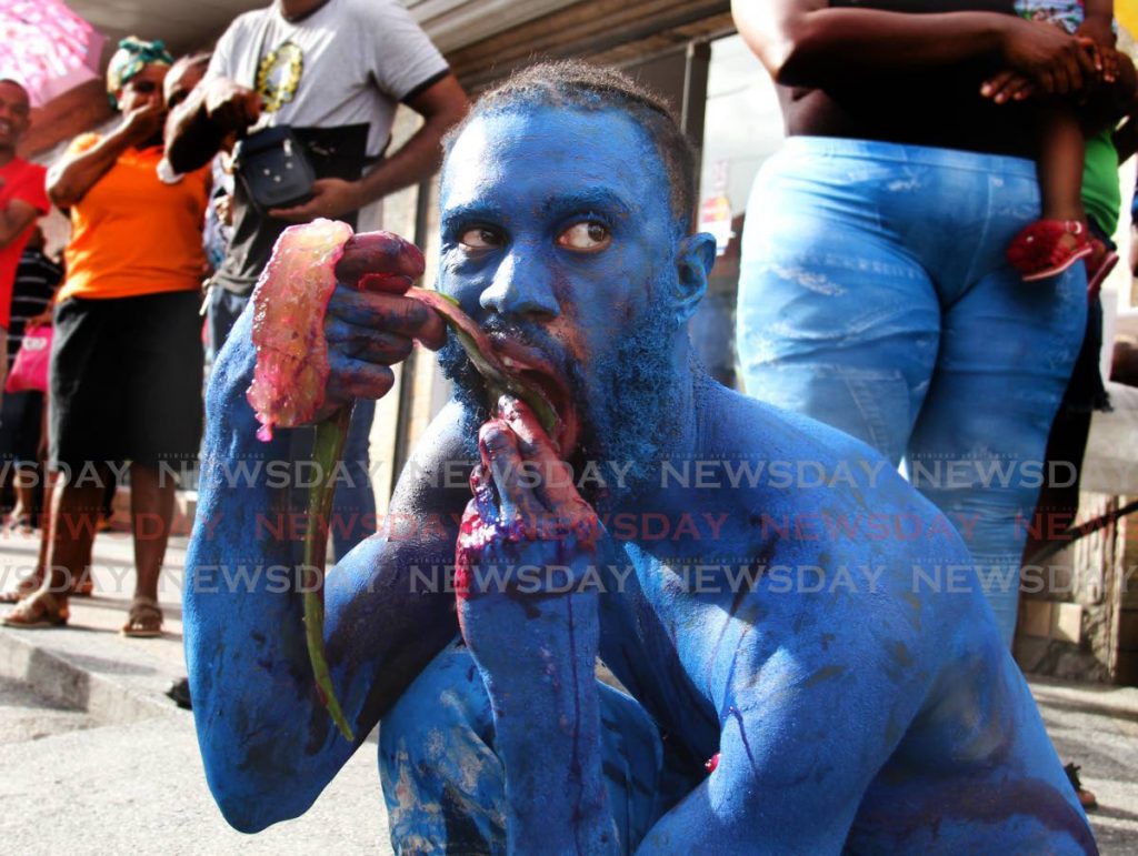 VEGAN DEVIL: A blue devil munches on some aloes during the Carnival launch. PHOTO BY AYANNA KINSALE 