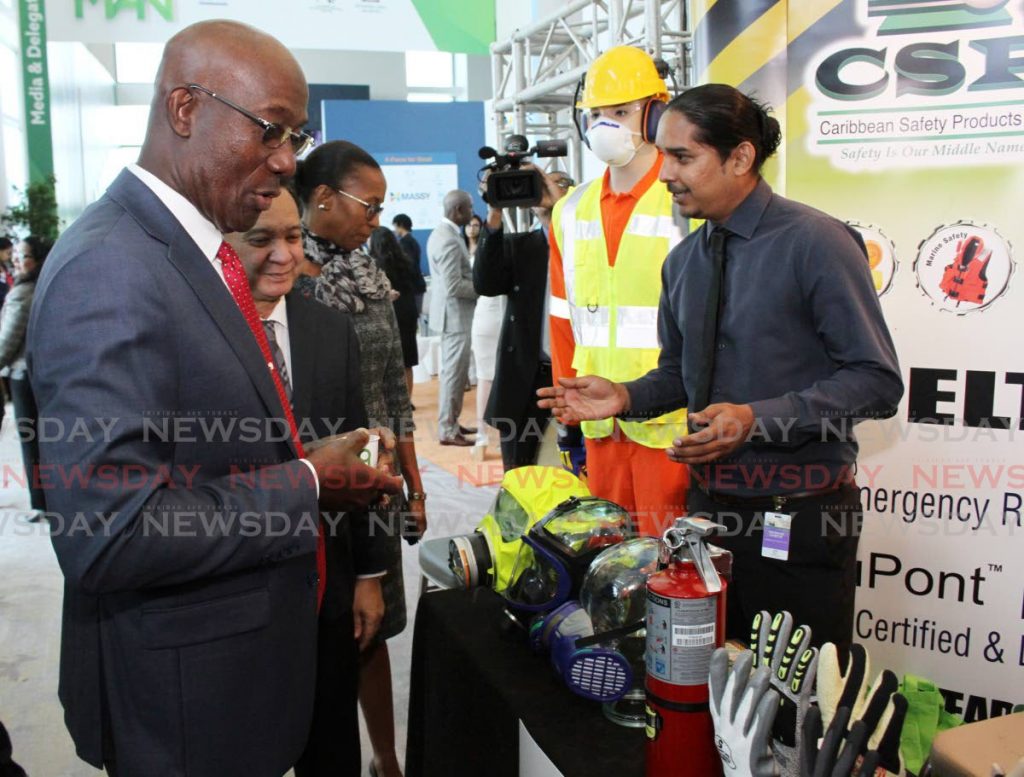 Prime Minister Dr Keith Rowley, Energy Minister Franklin Khan and La Brea MP Nicole Nicole Olivierre, look at safety equipment from Caribbean Safety Products at the TT Energy Conference 2020 at Hyatt Regency, Port of Spain on Monday.      - ANGELO_MARCELLE