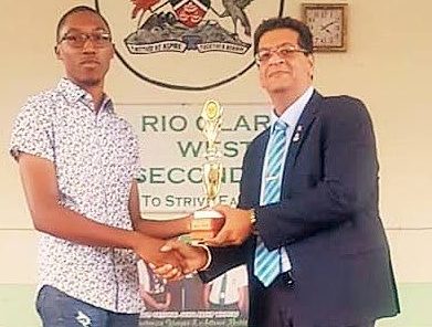 WELL DONE: MP Rushton Paray presents an award to National Scholarship recipient and former Rio Claro West Secondary school student Antonio Beckles. - 