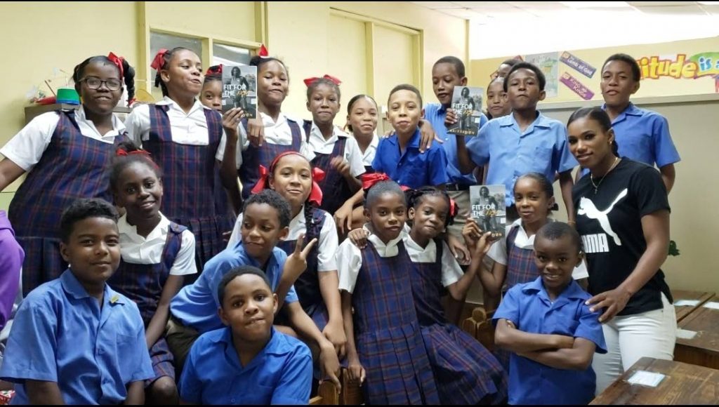 Two-time Olympian and TT sprinter Kai Selvon (L) takes a photo with students recently during her school tour as part of her Fit for the Fight campaign. - 
