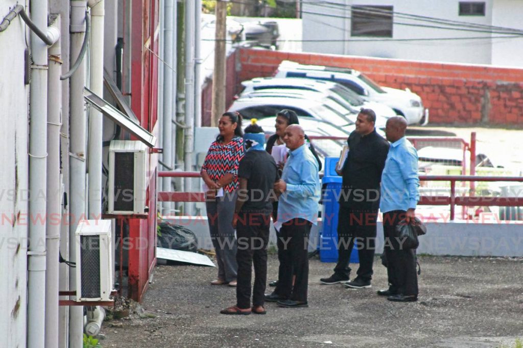 The 17-year-old suspect in the killing of Dr Rudradeva Sharma and another man is taken to the San Fernando magistrates' court on Wednesday.  PHOTO BY MARVIN HAMILTON - 