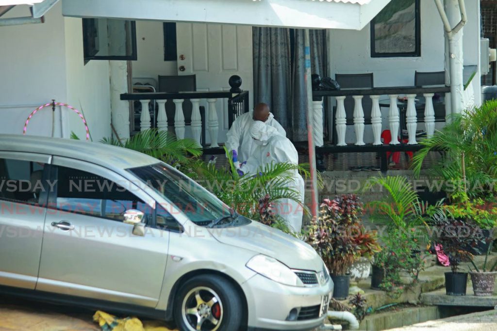 Crime scene investigators dust for finger prints, at the scene where Marlon Le Guerre was murdered early on Tuesday morning at Embacadere. - CHEQUANA WHEELER