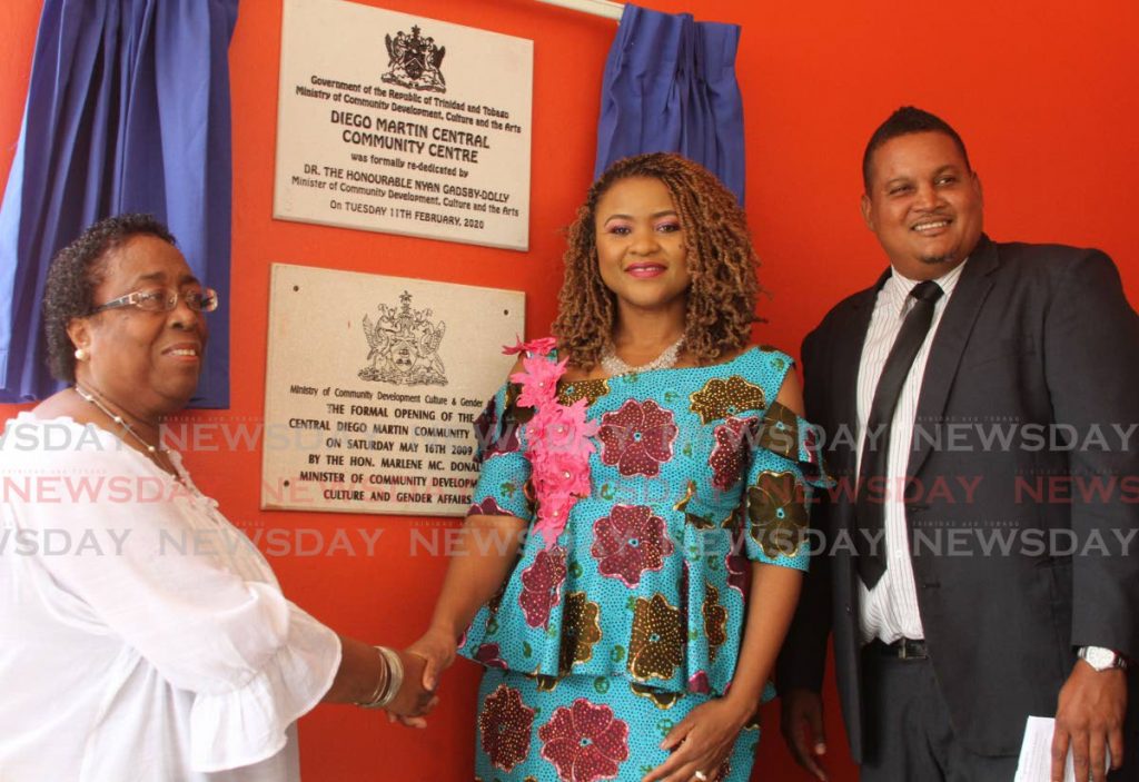 SUPPORTING THE COMMUNITY: Minister of Community Development, Culture and the Arts Nyan Gadsby-Dolly, centre, and president of the Central Diego Martin Community Council Lynette Ward shake hands as they unveil the commemorative plaque at the Central Diego Martin Community centre. Member of Parliament, Diego Martin Central Darryl Smith looks on. PHOTO BY AYANNA KINSALE  - Ayanna Kinsale