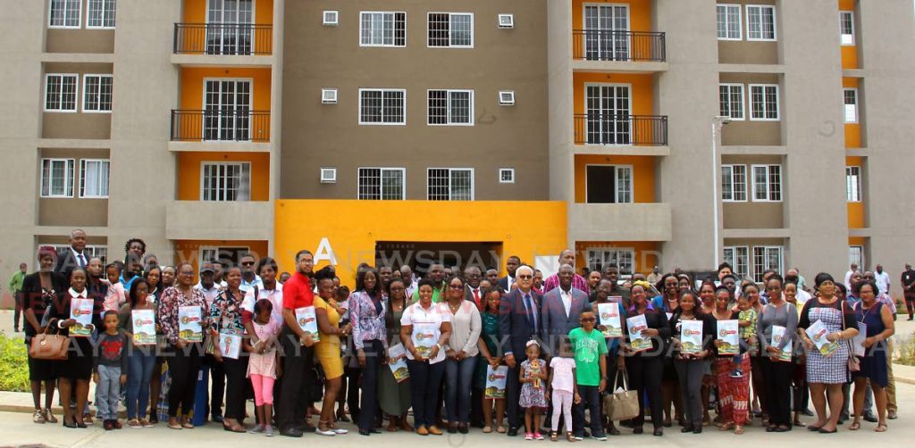 Prime Minister Dr Keith Rowley, St Joseph MP Terrence Deyalsingh and Communications Minister Donna Cox with 73 recipients and their families at a HDC key distribution ceremony for units in Building A of Mahogany Court, Mt Hope, on Wednesday. - ROGER JACOB