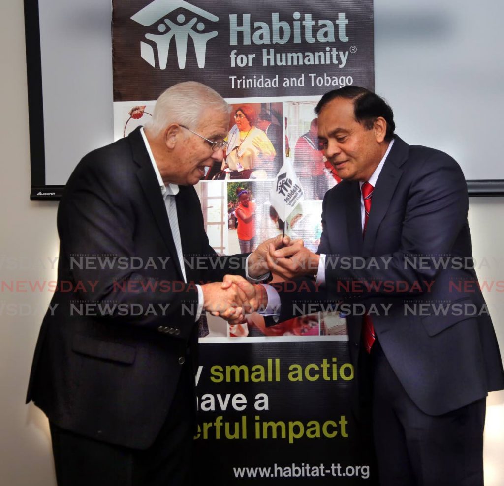 PASSING THE BATON: Outgoing Habitat for Humanity chair Ronald Harford, left, hands over the leadership of the organisation to businessman Sieunarine Coosal at a ceremony at the Courtyard at Marriot, Invaders Bay, Port of Spain, recently. Photo by Sureash Cholai. - SUREASH CHOLAI