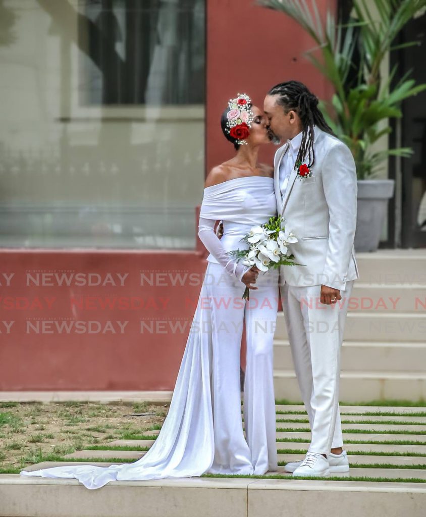 Machel Montano kisses his bride, Renee Butcher, after they “tied the knot” at the Red House on Abercromby Street in Port of Spain on Friday. It was the first marriage conducted at the Red House since its restoration and reopening in January this year. - ROGER JACOB