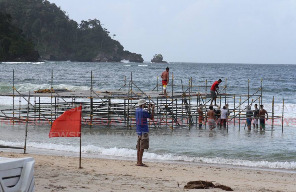Work continues on stage being built into the sea at Maracas Bay for the Karukera One Love on February 21.  - ANGELO_MARCELLE