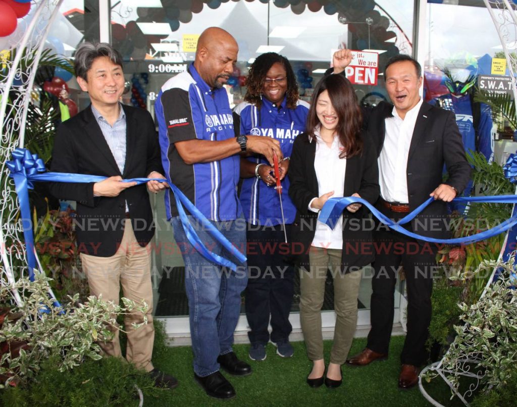 From left, general manager OMDO Nobuhiko Najajima, Greene's General Cycle Ltd Founder Alan Greene and his wife, head of Yamaha Caribbean Group Division Japan Yukina Ota and Yamaha Group Central America and Caribbean sales manager Shigeo Uchiyama cut the ribbon to formerly open the Greene's General Cycle Ltd showroom, at Old Southern Main Road South, Valsayn on Sunday. - ANGELO MARCELLE
