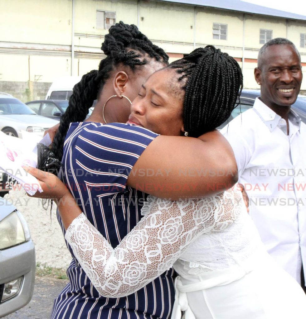 Maysonia Thomas, centre, mother of Mukeisha Maynard, is consoled at her funeral, at Simpsons Memorial Ltd Chapel, Eastern Main Road, Laventille. - Angelo Marcelle