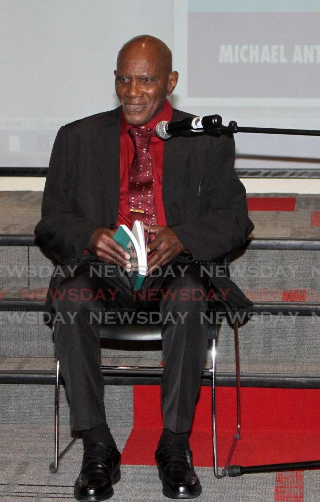 Michael Anthony, 90, explains his new book The Sound of Marching Feet is based on his boyhood during the World War II era during a launch at the National Library, Port of Spain on February 19. - ANGELO_MARCELLE