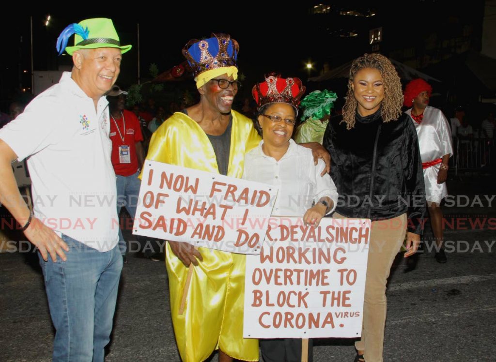 WINNERS: Port of Spain Mayor Joel Martinez, left, and Arts and Culture Minister Dr Nyan Gadsby-Dolly, right, congratulate the King and Queen of J’Ouvert, Herbert Pierre and his daugter Lillian. 
 - ROGER JACOB