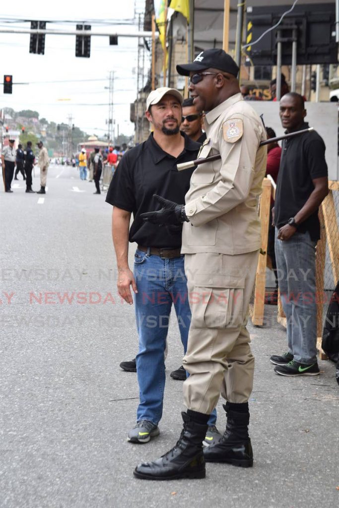 National Security Minister Stuart Young speaks with a policeman during a spot check on Carnival Monday at South Quay in Port of Spain.  - Vidya Thurab