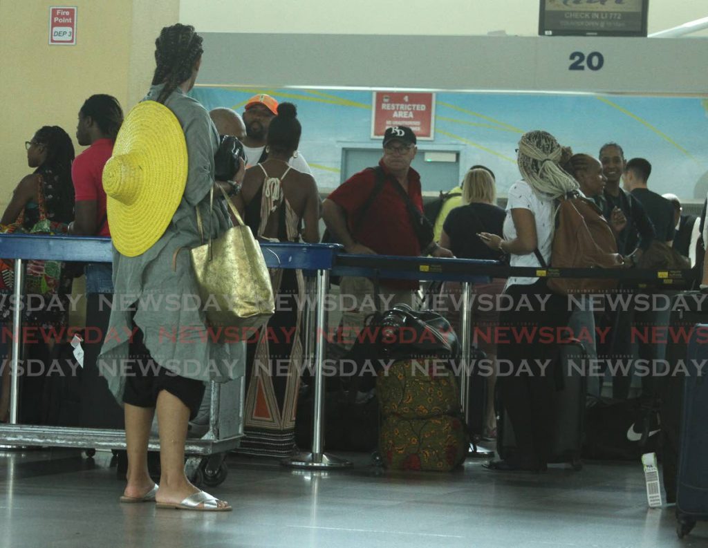Passengers waiting to check in at the Piarco International Airport on Wednesday. 
PHOTO BY AYANNA KINSALE 2020.02.26 - Ayanna Kinsale