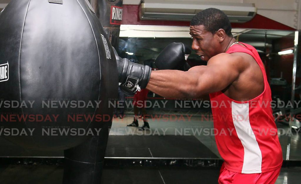 In this file photo, TT boxer and 2016 Olympian Nigel Paul punches  the bag during a training session.  - Angelo Marcelle