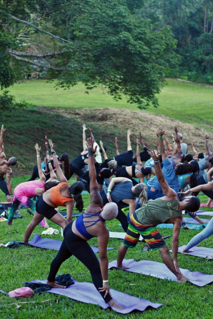 This file photo shows a group of people doing yoga at Ortinola Estate, St Joseph. We can meet covid19 with a pandemic of our own making: a pandemic of wellness. - 