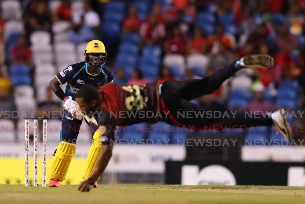 Chris Jordan of Trinbago Knight Riders (front) takes a return catch off Barbados Tridents' Jonathan Carter during A Hero Caribbean Premier League match, on October 10,2019. (Photo courtesy CPL T20) - 