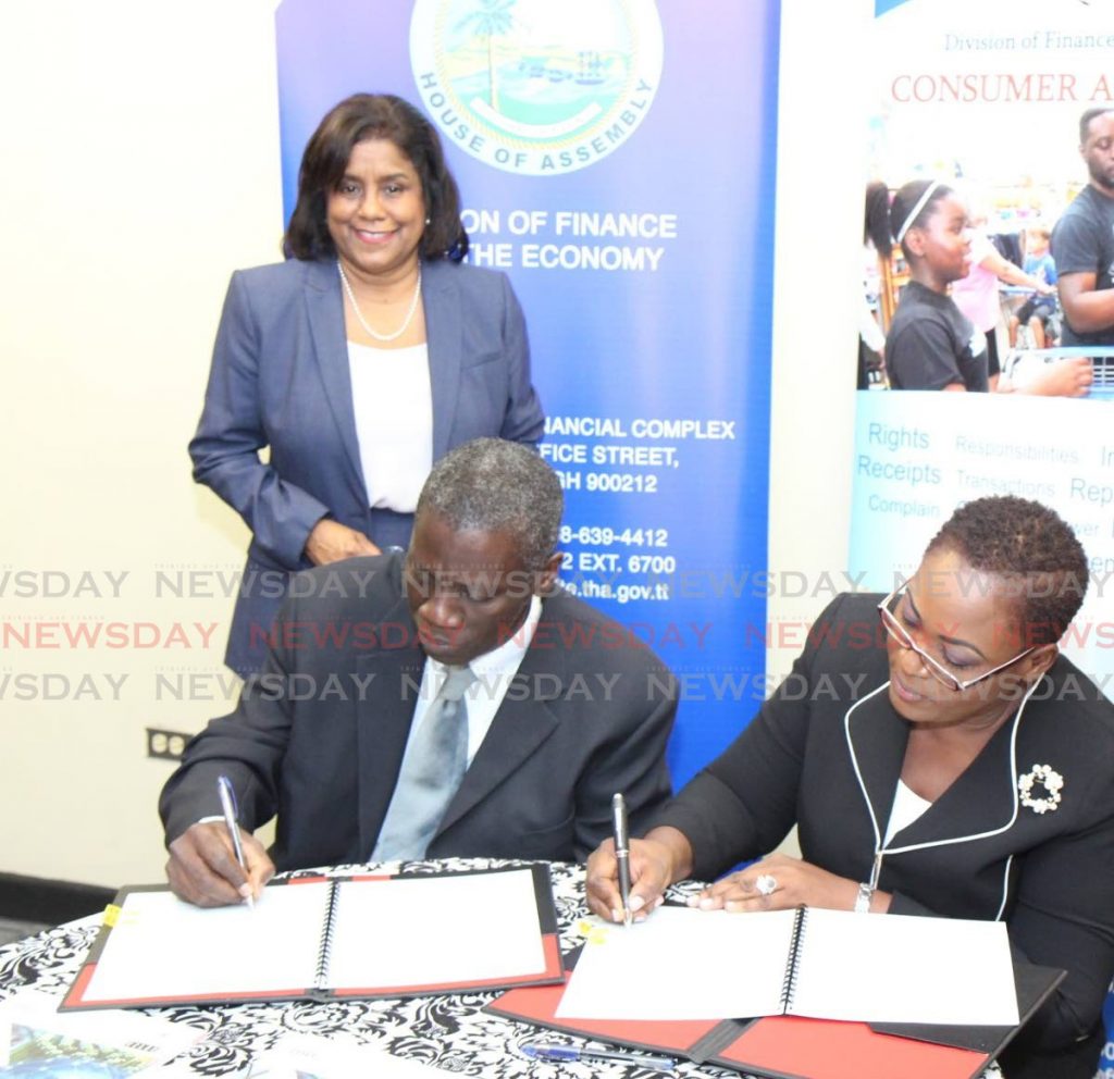 In this November 2019 file photo, Trade and Industry Minister Paula Gopee-Scoon looks on as Ministry of Trade and Industry PS Norris Herbert and THA administrator, finance and economy Denese Toby-Quashie sign an agreement at the Victor E Bruce Financial Complex, Scarborough. Gopee-Scoon on Friday said the pandemic leave policy should be announced this week. - 