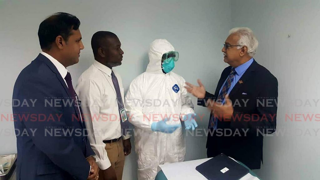 Minister of Health Terrence Deyalsingh with Permanent Secretary Asif Ali and Chief Medical Officer Roshan Parasram during a tour of the Piarco Airport. - 